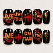 ACEGRIP Onyx Backstage press-on nails in black, orange, red, and gold tones, with music-inspired motifs, style AN8043