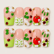 ACEGRIP Blush Orchard press-on nails in peach nude, green, white, and red, with apple motifs, style AN8103