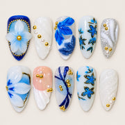 ACEGRIP Ivory Petal Sculpture press-on nails in white, blue, peach nude, and gold tones, with floral accents, style DX7083