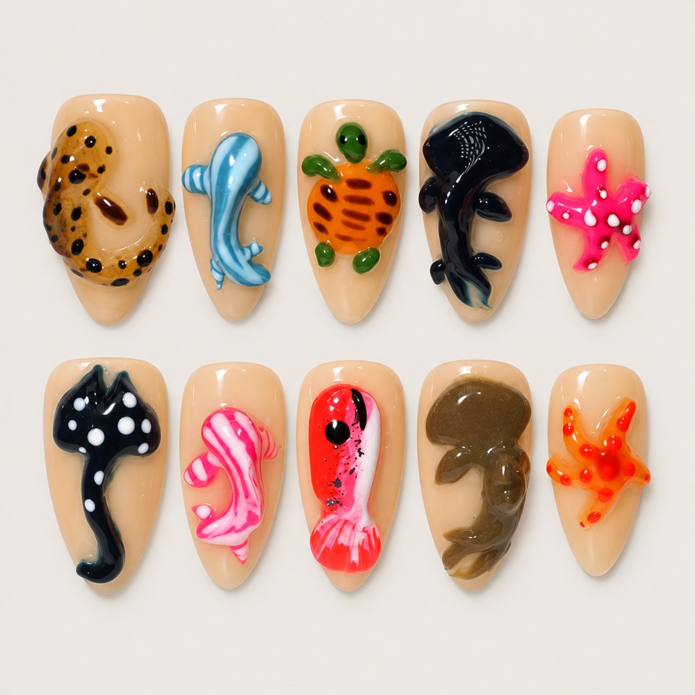 ACEGRIP Blush Seaside Fish Tales press-on nails in peach nude, black, blue, and pink, with ocean-inspired motifs, style DX7120