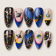 ACEGRIP Onyx Orbit press-on nails in black, blue, peach nude, and silver tones, with planet motifs, style FD9012