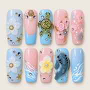 ACEGRIP Azure Seaside Turtle press-on nails in blue, pink, peach nude, and gold tones, with ocean-inspired motifs, style XQ2024